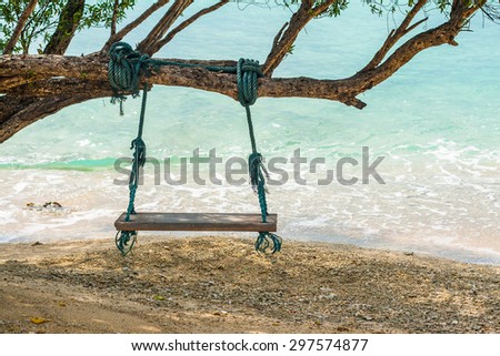 Wood swing on the beach under the tree