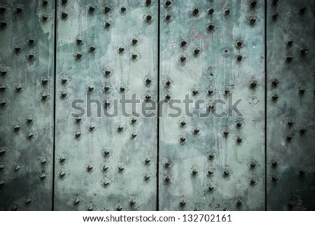 Old metallic door panel making abstract background.