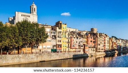 Urban landscape of Girona with it great Cathedral and colorful river houses.