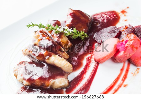 Duck magret meat with beet and cherry sauce, ready to eat.