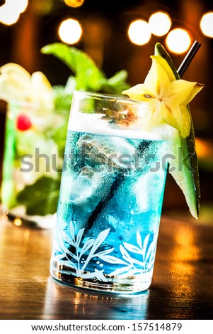 Cold blue cocktail in a night party.