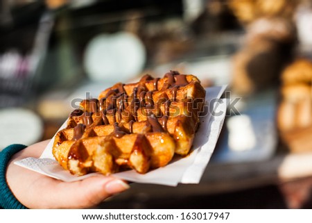 Typical belgian waffle in the street, ready to eat.