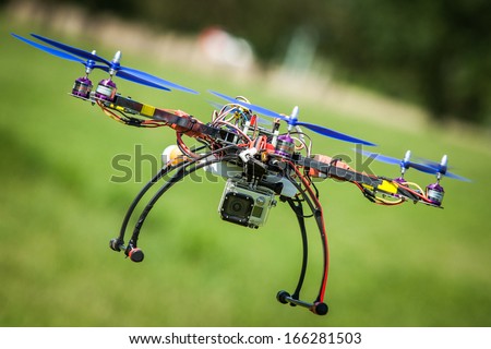 Remote drone flying with video camera on board.