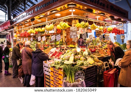 BARCELONA, SPAIN - 11 MARCH: People visit and buy food in the most famous market in the city called La Boqueria in Barcelona. Barcelona March 3, 2014.