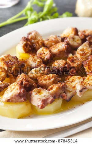 Typical spanish meal with octopus, potatoes, coarse salt, paprika and olive oil. Original dish from Galicia, Spain.