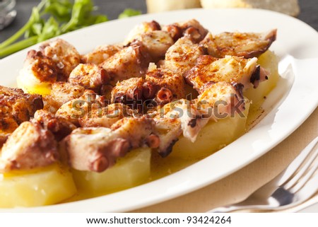 Typical spanish meal with octopus, potatoes, coarse salt, paprika and olive oil. Original dish from Galicia, called \
