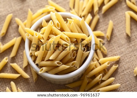 Bunch of italian macaroni on a bowl, ready to cook.
