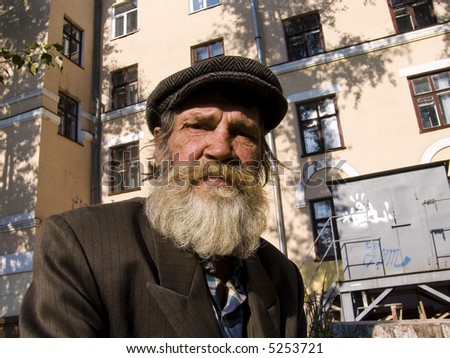 The old bearded man on a urban background