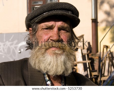 The old bearded man on a urban background