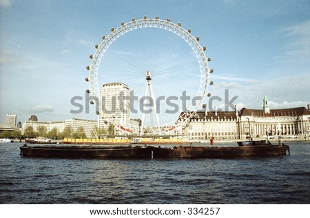 boat and London Eye on Thames River in London