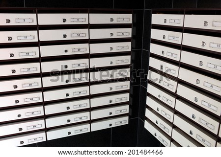 Post boxes or two wooden cabinets with multiple white fronted drawers for storage of implements, stock or a collection of small items