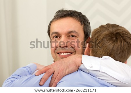 Emotional tight hug of father and son. Sincere love of parent and child