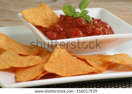 tortilla chips with a bowl of salsa dip