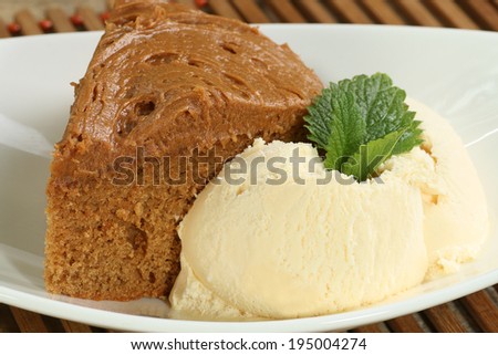 Slice of toffee fudge cake with vanilla ice cream