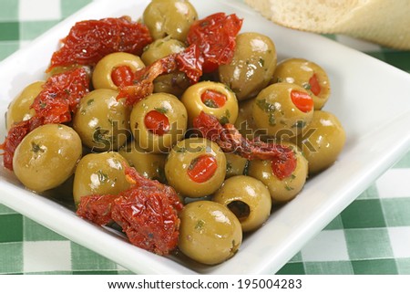 dish of pimento stuffed green olives with sun dried tomatoes