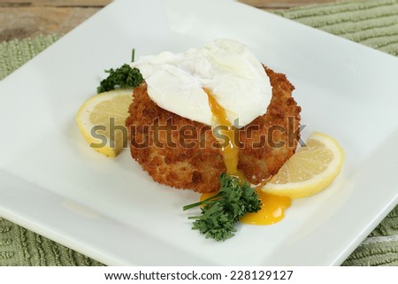 cod fish cake topped with a poached egg