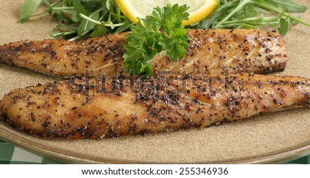 grilled mackerel fillets seasoned with pepper corns with lemon and parsley