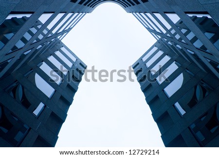 key business concept - symmetrical steel blue business building forms a solid white keyhole shape