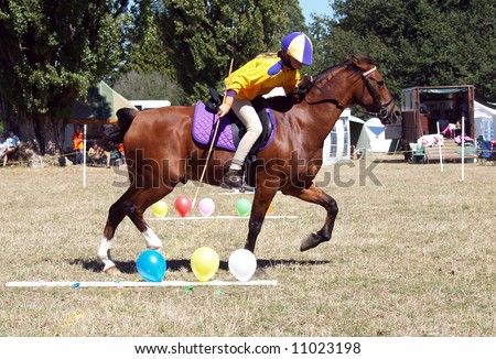 Pony club games with the rider about to pop a balloon