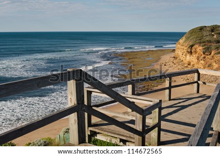 Australia famous surfing beach Bells Beach at low tide with surfers in the water and empty lookout with space