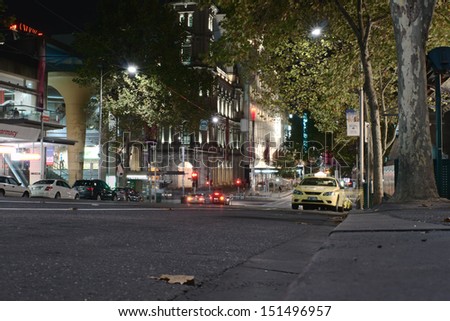 MELBOURNE, AUSTRALIA - MAY 06, 2013: Taxi cabs and night on Bourke street at night on May 6, 2013, Melbourne, Australia. Bourke street is one of central streets in Melbourne with offices and shops