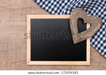 Blackboard and heart on table