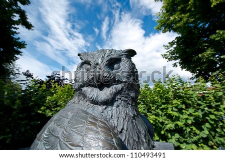 Statue of an Owl against a summer sky in Oslo botanical garden