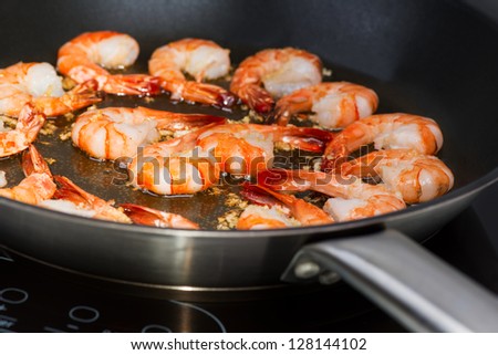 Chinese cooking: Shrimp in wok on cook top
