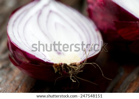 Fresh red onion cross cut on an old wooden table