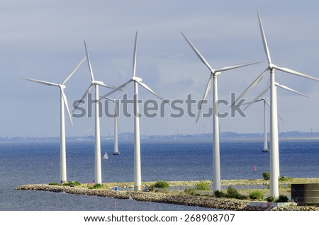 white wind turbine generating electricity on sea