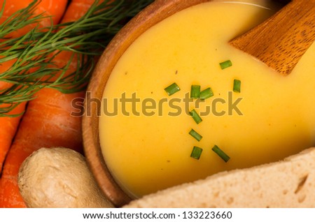 Fresh Vegan Carrot and Potato Soup surrounded by its ingredients