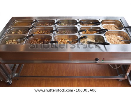 Chinese buffet warmer display with variety of food in containers isolated on white