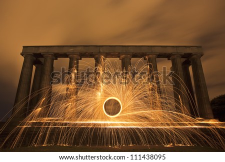 Spiral Sparking fire ring on National Monument, Edinburgh, Scotland.. Night scene