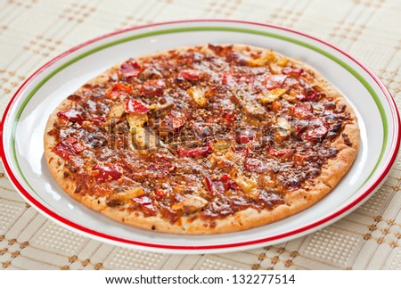 Well baked pizza served on plate