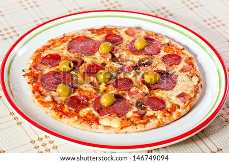 Bacon and pepperoni pizza with green olives. More food photographs in my portfolio.