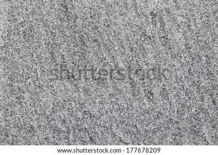 Closeup of grey granite texture as a wallpaper concept for designers background applying