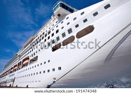 Bow of white modern mega cruise ship docked at sea port