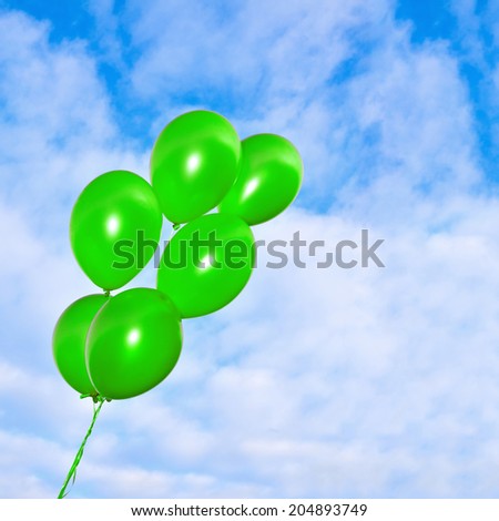 Bunch of flying inflatable golden balloons on the beautiful sky background