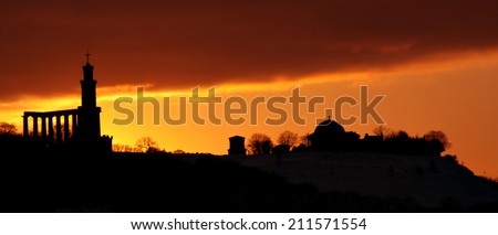Silhouette of  historical monuments on Calton hill  as Edinburgh city skyline with dramatic sky background