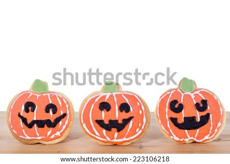Halloween cookies displayed on wooden board isolated on white background