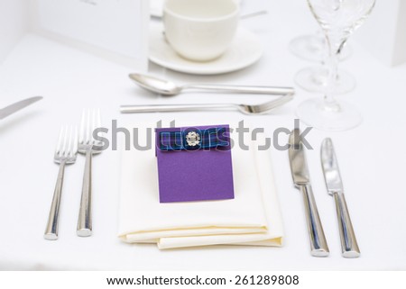 Luxury scottish wedding gala table setting with purple blank personal greeting card