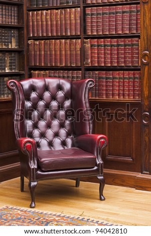 Traditional Chesterfield armchair in classical library room