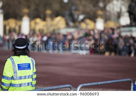 Community support police officer on duty. Daytime in public place outdoor