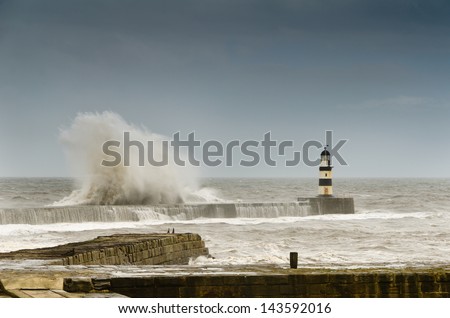 Crashing waves over Seaham Harbour / Crashing waves over the north pier in a rough sea at Seaham Harbour