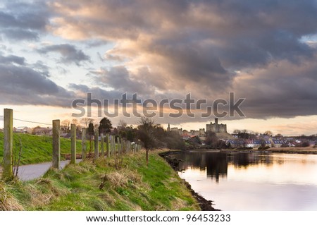 Clouds over Warkworth Castle / Atmospheric sky reflecting Warkworth Castle in the river Coquet