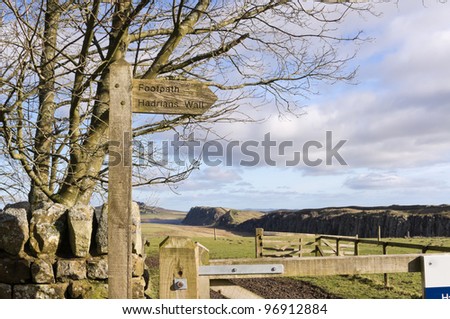 Hadrians Wall sign post / Sign post to Hadrians Wall with Steel Rigg and Crag Lough behind