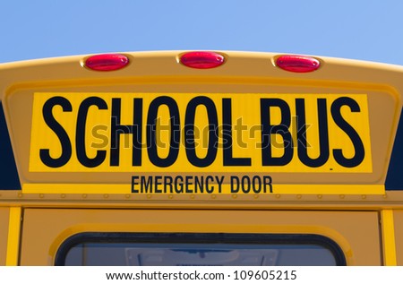 Back of school bus with a sign