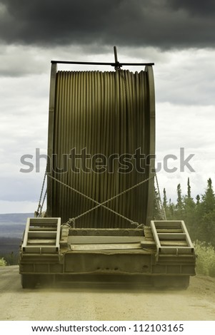 Truck with oversize load on the gravel road of Alaska