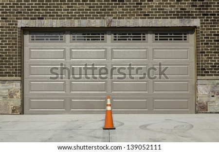 Two car wooden garage with traffic cone