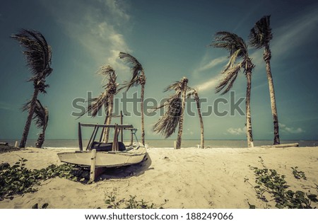 Small fishing boat on the beach of Natal, Brazil - vintage look